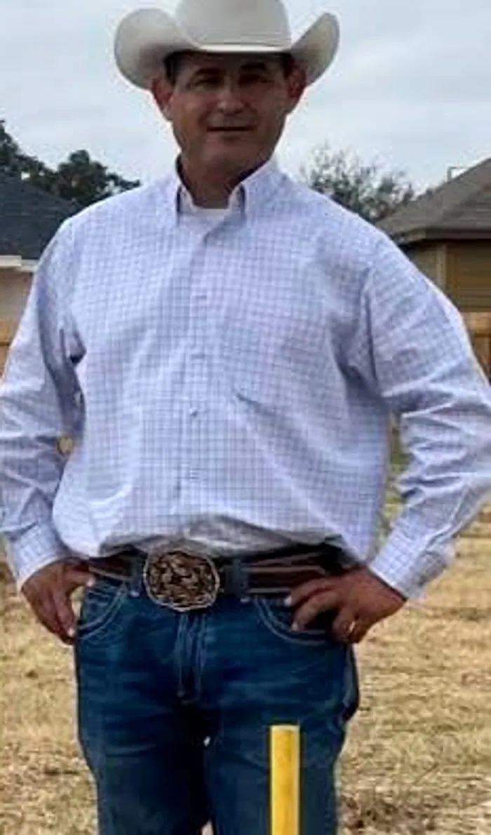 Darran Salmeron of Cheyenne Custom Homes standing on a lot in a white hat